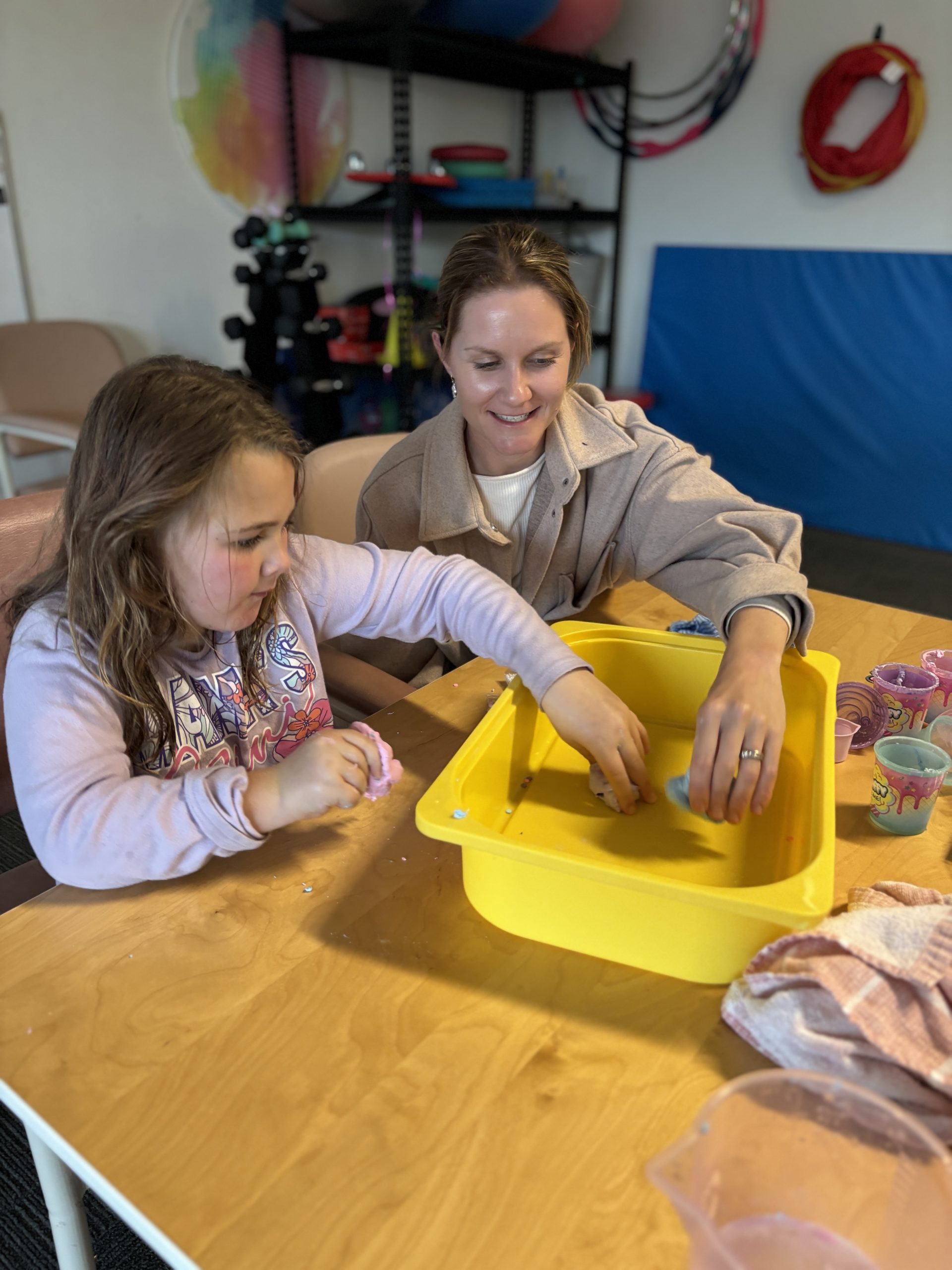 Rachel Rickwood, our creative Occupational Therapist plays with slime for therapeutic purposes with Paige at SensesWA Busselton.