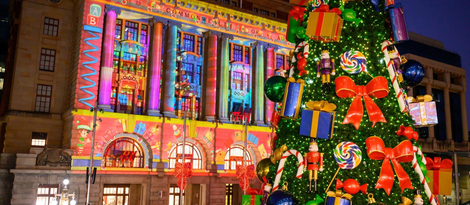 Image of a large decorated Christmas tree and a building with a colourful light projection at night. Rio Tinto Christmas Lights Trail Proudly brought to you by the City of Perth, principle partner Rio Tinto and major supporter Lotterywest.